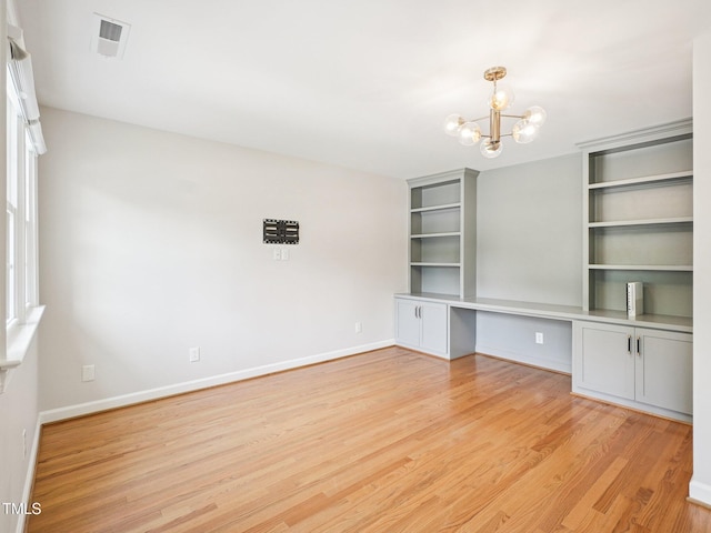 305 Promontory Point Dr, Cary, NC 27513 - unfurnished room featuring light wood finished floors, a chandelier, and baseboards