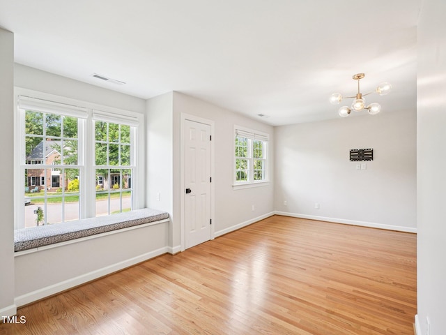 305 Promontory Point Dr, Cary, NC 27513 - empty room with light wood-style floors, a chandelier, and baseboards