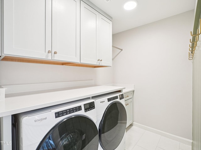 305 Promontory Point Dr, Cary, NC 27513 - washroom featuring separate washer and dryer, cabinet space, light tile patterned floors, and baseboards