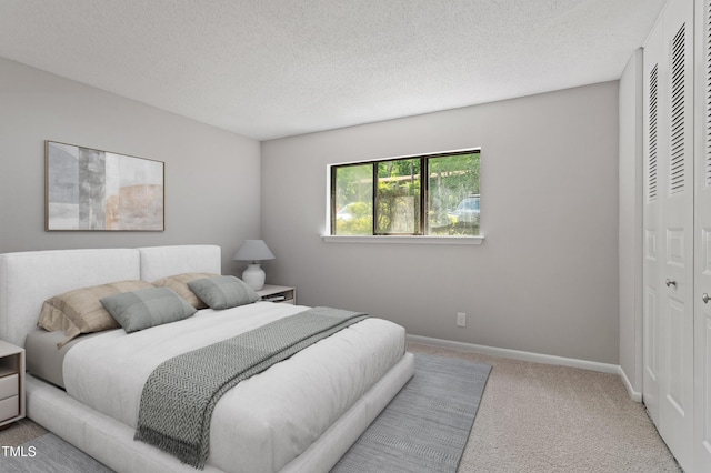 3088 Colony Rd Unit A, Durham, NC 27705 - carpeted bedroom featuring a closet, a textured ceiling, and baseboards