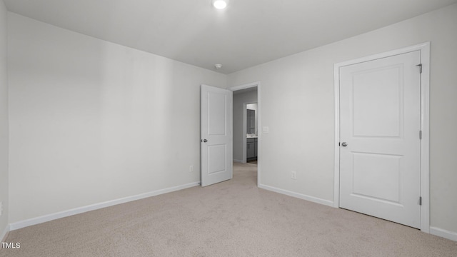 2122 Monk Dr, Haw River, NC 27258 - unfurnished bedroom with baseboards and light carpet