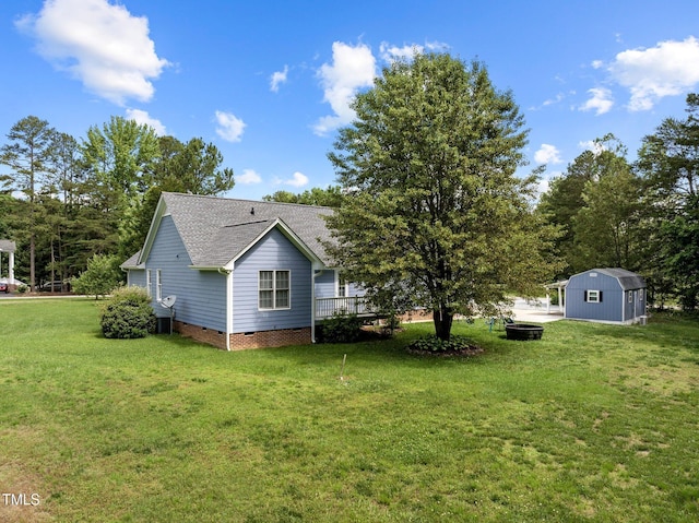 304 Foxcroft Dr, Timberlake, NC 27583 - view of home's exterior featuring a shed, crawl space, roof with shingles, and a yard