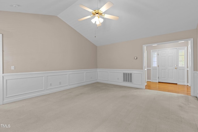 304 Foxcroft Dr, Timberlake, NC 27583 - unfurnished room featuring lofted ceiling, light colored carpet, a wainscoted wall, a ceiling fan, and a decorative wall