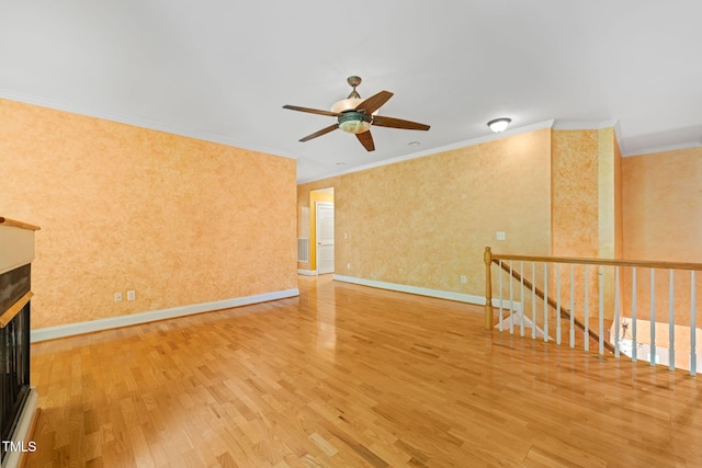 4831 Crestmore Rd Unit 202, Raleigh, NC 27612 - spare room with wood finished floors, ceiling fan, ornamental molding, and a glass covered fireplace