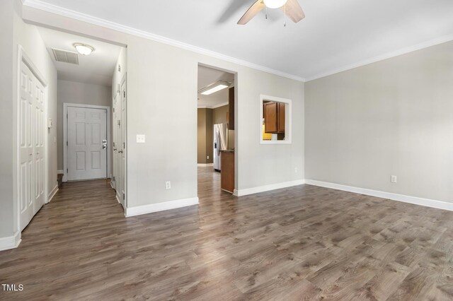 2623 Broad Oaks Pl, Raleigh, NC 27603 - empty room with ceiling fan, dark wood finished floors, baseboards, and crown molding