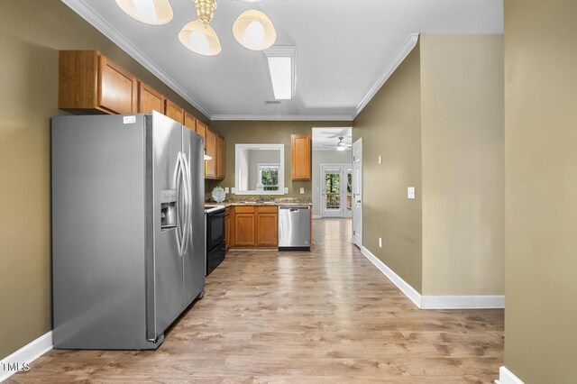 2623 Broad Oaks Pl, Raleigh, NC 27603 - kitchen with stainless steel appliances, ornamental molding, light wood finished floors, ceiling fan, and light countertops