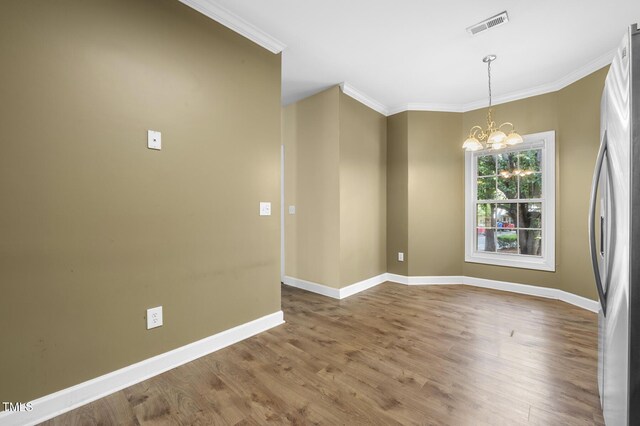 2623 Broad Oaks Pl, Raleigh, NC 27603 - empty room with a chandelier, ornamental molding, wood finished floors, and baseboards