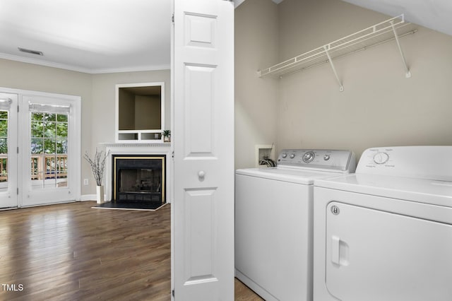 2623 Broad Oaks Pl, Raleigh, NC 27603 - laundry room with washing machine and dryer, ornamental molding, wood finished floors, a fireplace, and baseboards