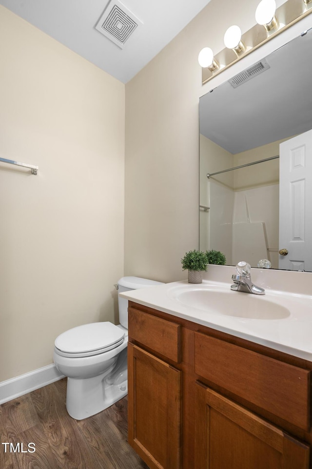 2623 Broad Oaks Pl, Raleigh, NC 27603 - full bath featuring vanity, toilet, wood finished floors, and a shower