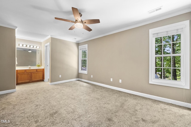 2623 Broad Oaks Pl, Raleigh, NC 27603 - unfurnished bedroom with multiple windows, baseboards, ornamental molding, light colored carpet, and ensuite bath