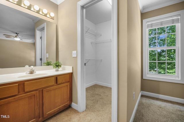 2623 Broad Oaks Pl, Raleigh, NC 27603 - bathroom with vanity, ornamental molding, a ceiling fan, baseboards, and a walk in closet