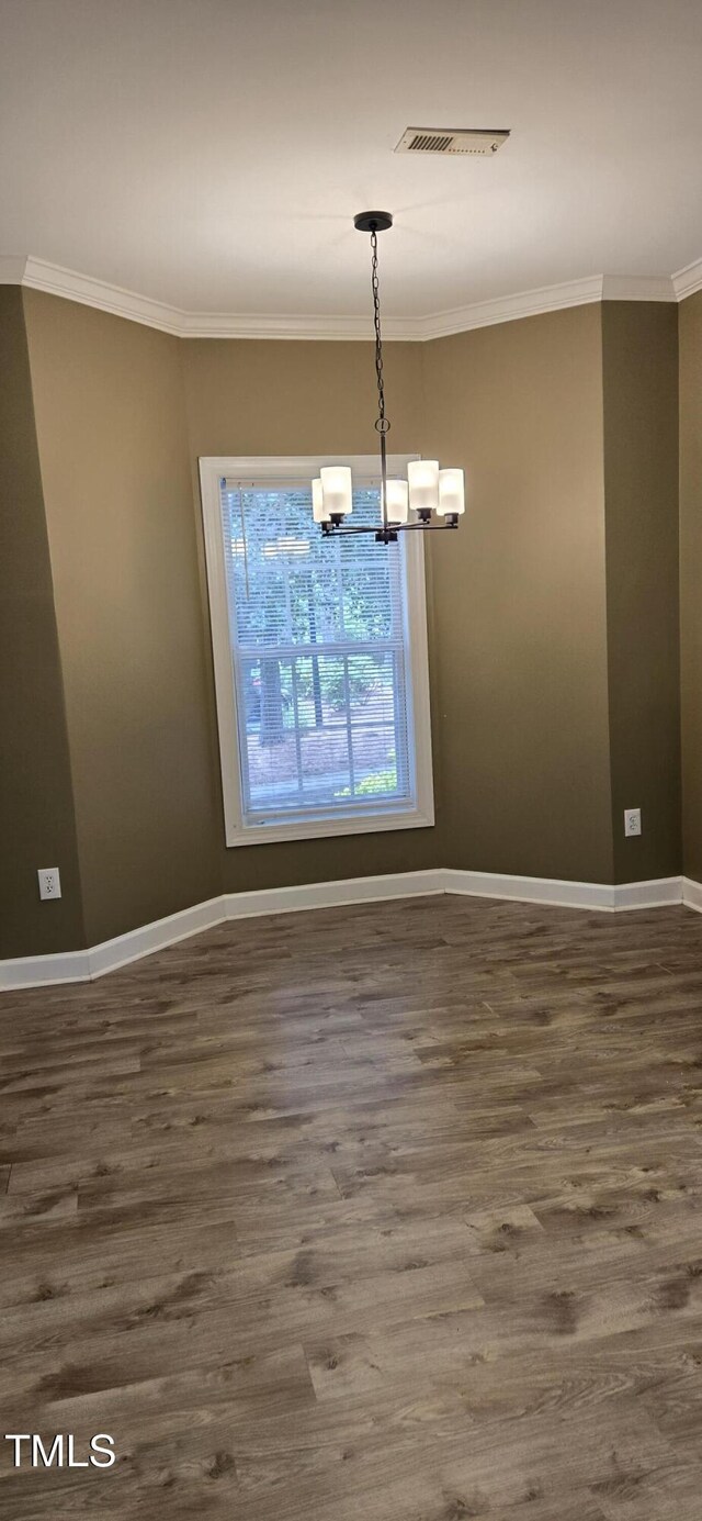 2623 Broad Oaks Pl, Raleigh, NC 27603 - unfurnished dining area featuring ornamental molding, a chandelier, dark wood finished floors, and baseboards
