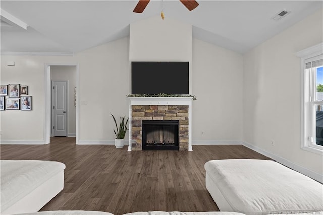 117 Titleist Ct, Raeford, NC 28376 - bedroom with vaulted ceiling, dark wood-type flooring, a stone fireplace, baseboards, and a ceiling fan