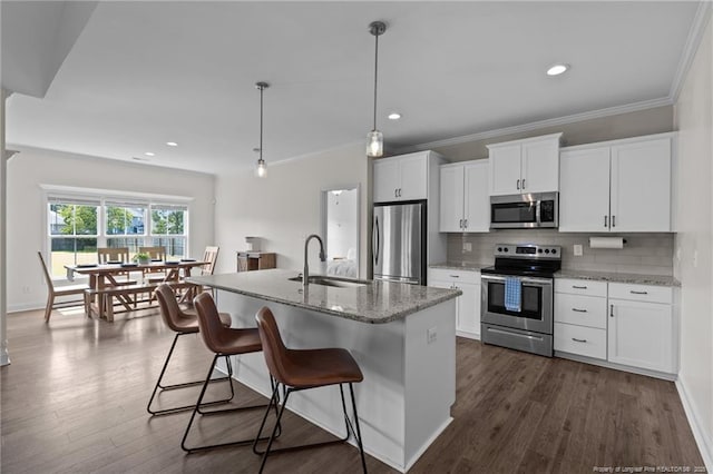 117 Titleist Ct, Raeford, NC 28376 - kitchen featuring stainless steel appliances, a sink, tasteful backsplash, a breakfast bar, and a kitchen island with sink