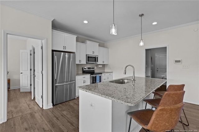 117 Titleist Ct, Raeford, NC 28376 - kitchen with stainless steel appliances, a sink, ornamental molding, a kitchen breakfast bar, and a center island with sink