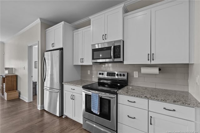 117 Titleist Ct, Raeford, NC 28376 - kitchen with stainless steel appliances, ornamental molding, white cabinets, light stone counters, and decorative backsplash