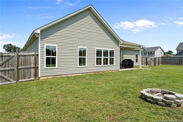 117 Titleist Ct, Raeford, NC 28376 - rear view of property with an outdoor fire pit