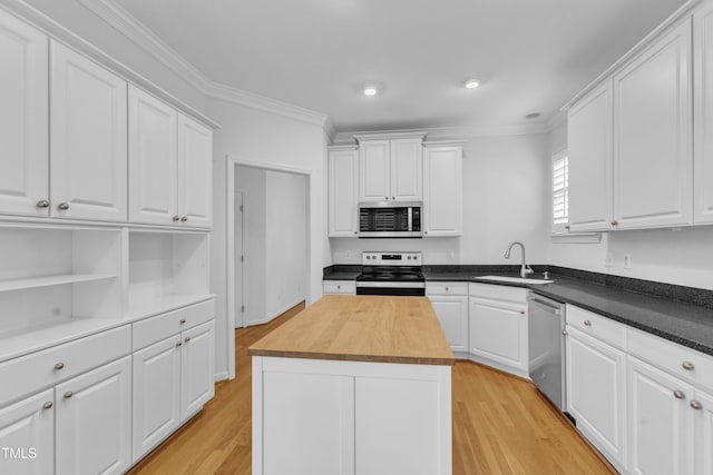 500 Center Pointe Dr, Cary, NC 27513 - kitchen featuring stainless steel appliances, a sink, wood counters, ornamental molding, and white cabinets