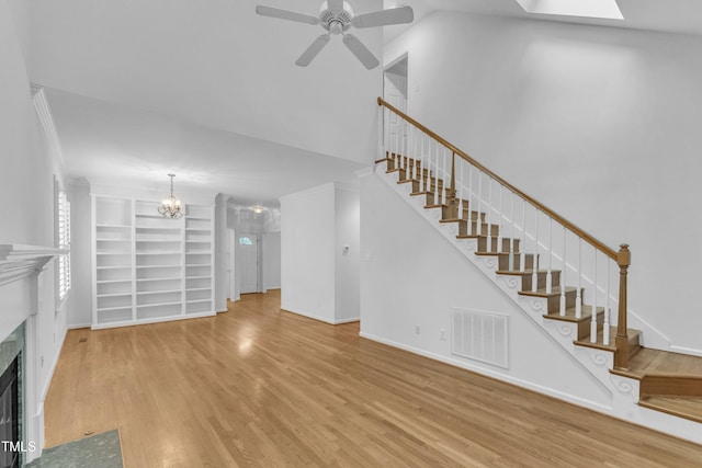 500 Center Pointe Dr, Cary, NC 27513 - unfurnished living room featuring wood finished floors, stairs, a high end fireplace, ceiling fan, and ornamental molding