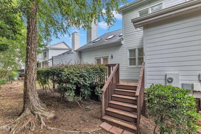 500 Center Pointe Dr, Cary, NC 27513 - rear view of house with a deck, a shingled roof, a chimney, and stairway