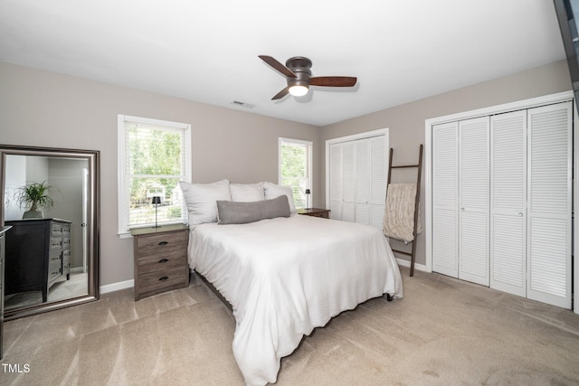 4604 Townesbury Ln, Raleigh, NC 27612 - bedroom with multiple closets, light carpet, baseboards, and ceiling fan