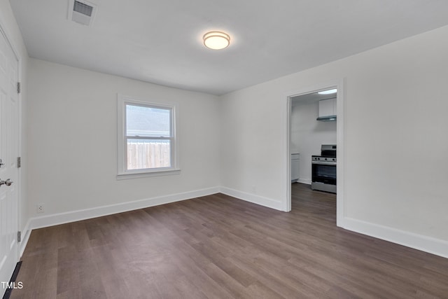 414 Craven St, Durham, NC 27704 - spare room featuring dark wood-type flooring and baseboards