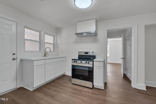 414 Craven St, Durham, NC 27704 - kitchen featuring stainless steel range with electric cooktop, under cabinet range hood, wood finished floors, and light countertops