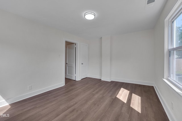 414 Craven St, Durham, NC 27704 - unfurnished room featuring dark wood-type flooring, healthy amount of natural light, and baseboards