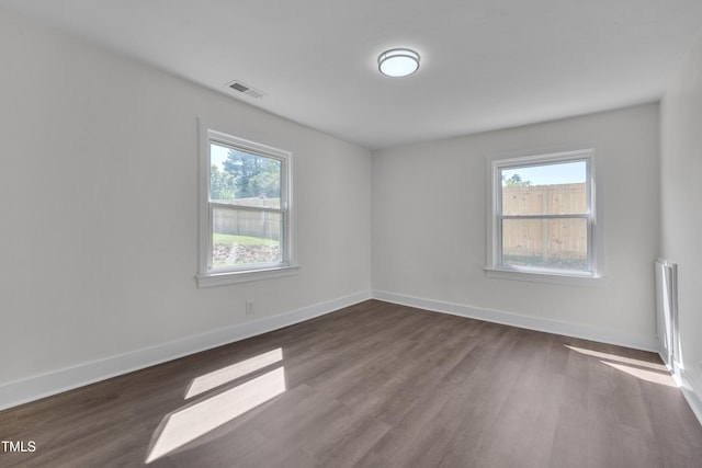 414 Craven St, Durham, NC 27704 - empty room featuring healthy amount of natural light, dark wood-style floors, and baseboards