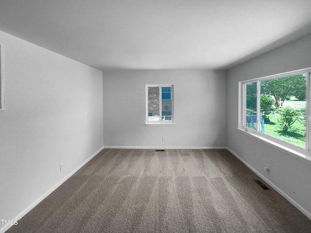 916 Waring St, Durham, NC 27704 - carpeted empty room with baseboards