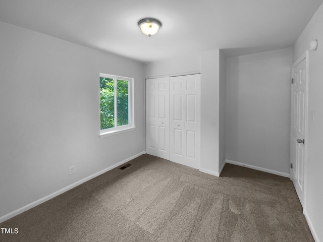 916 Waring St, Durham, NC 27704 - unfurnished bedroom with carpet, baseboards, and a closet