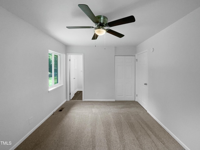 916 Waring St, Durham, NC 27704 - unfurnished bedroom featuring baseboards, a closet, carpet floors, and a ceiling fan