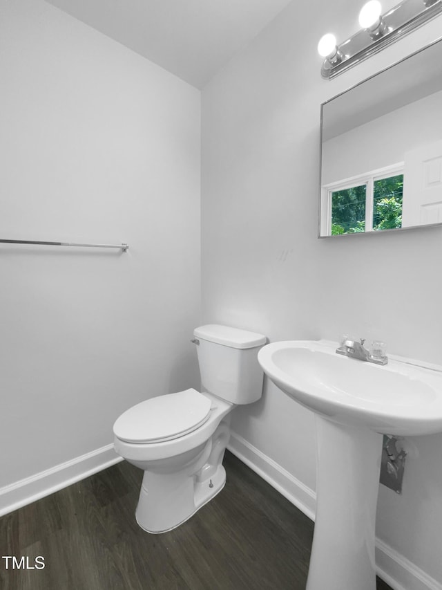 916 Waring St, Durham, NC 27704 - bathroom with baseboards, wood finished floors, and toilet