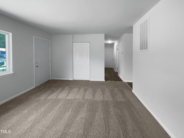 916 Waring St, Durham, NC 27704 - unfurnished bedroom featuring carpet, baseboards, and a closet