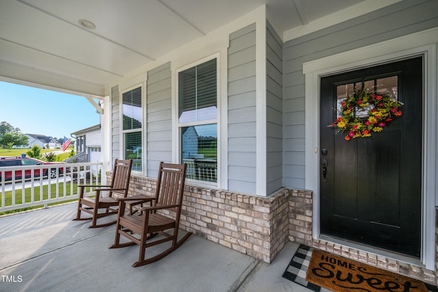 226 Castle Pond Way, Fuquay Varina, NC 27526 - view of exterior entry featuring covered porch and stone siding