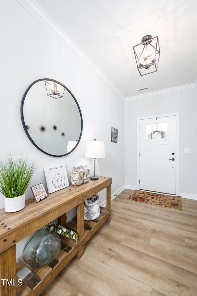 226 Castle Pond Way, Fuquay Varina, NC 27526 - foyer featuring crown molding, a chandelier, and wood finished floors