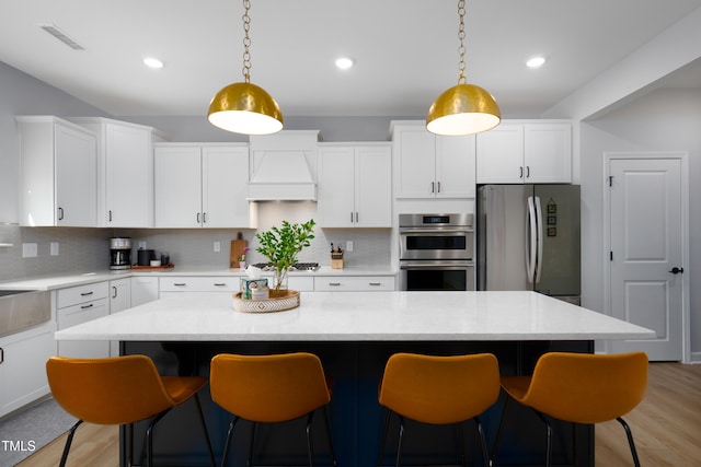 226 Castle Pond Way, Fuquay Varina, NC 27526 - kitchen with appliances with stainless steel finishes, white cabinetry, tasteful backsplash, light wood finished floors, and recessed lighting