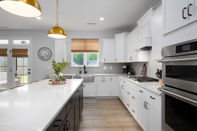 226 Castle Pond Way, Fuquay Varina, NC 27526 - kitchen featuring stainless steel appliances, light countertops, recessed lighting, white cabinets, and backsplash