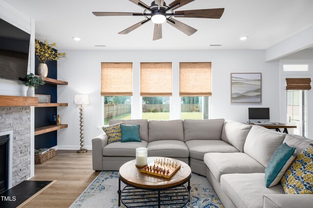 226 Castle Pond Way, Fuquay Varina, NC 27526 - living area with a ceiling fan, recessed lighting, wood finished floors, and a stone fireplace