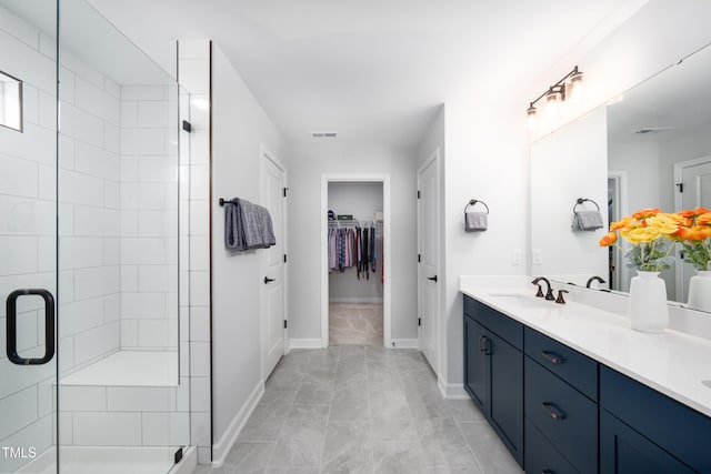 226 Castle Pond Way, Fuquay Varina, NC 27526 - bathroom with double vanity, a stall shower, and a walk in closet
