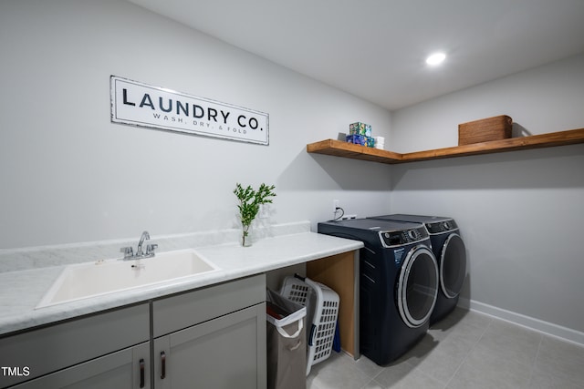226 Castle Pond Way, Fuquay Varina, NC 27526 - laundry area featuring washing machine and clothes dryer, cabinet space, and light tile patterned floors