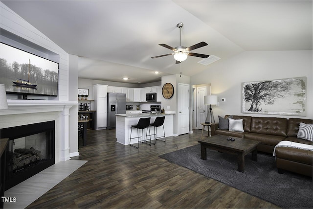 60 Falling Leaf Ln, Benson, NC 27504 - living area featuring ceiling fan, lofted ceiling, dark wood-type flooring, a fireplace with flush hearth, and recessed lighting