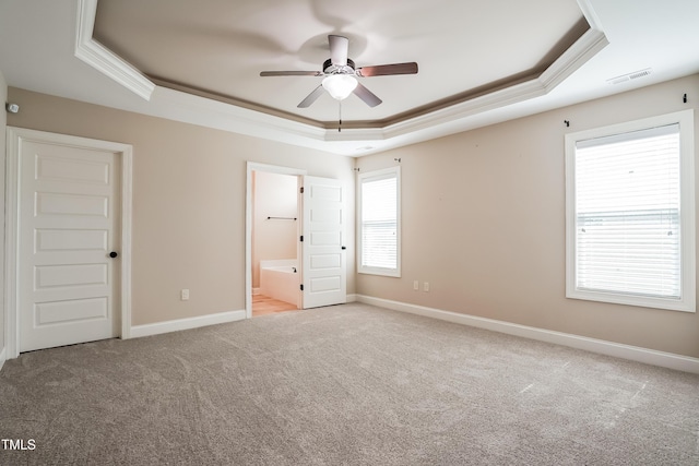 67 Bornean Dr, Garner, NC 27529 - unfurnished bedroom with a raised ceiling, crown molding, carpet flooring, baseboards, and ensuite bath