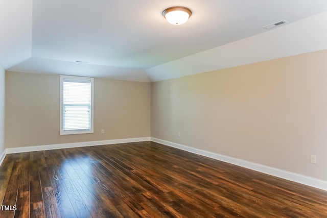 67 Bornean Dr, Garner, NC 27529 - spare room with lofted ceiling, dark wood finished floors, and baseboards