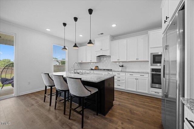 4508 Valley Crest Ln, Fuquay Varina, NC 27526 - kitchen featuring stainless steel appliances, crown molding, white cabinets, tasteful backsplash, and dark wood finished floors
