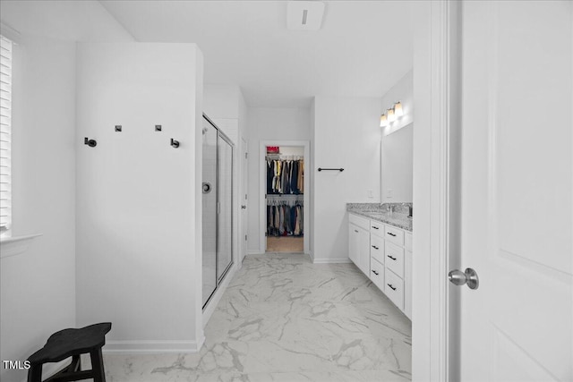 4508 Valley Crest Ln, Fuquay Varina, NC 27526 - bathroom with marble finish floors, double vanity, a shower stall, a spacious closet, and baseboards