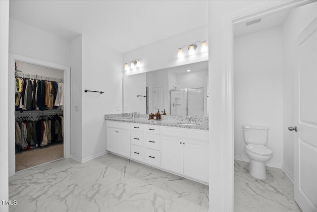 4508 Valley Crest Ln, Fuquay Varina, NC 27526 - bathroom featuring marble look tiles, double vanity, a shower stall, toilet, and a walk in closet