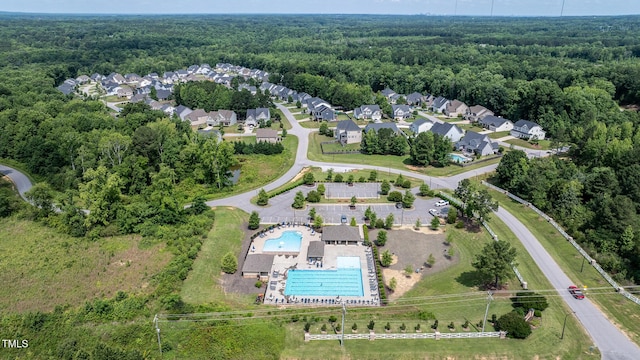 77 Redpine Ct, Clayton, NC 27520 - aerial view of property and surrounding area featuring a heavily wooded area and a pool area