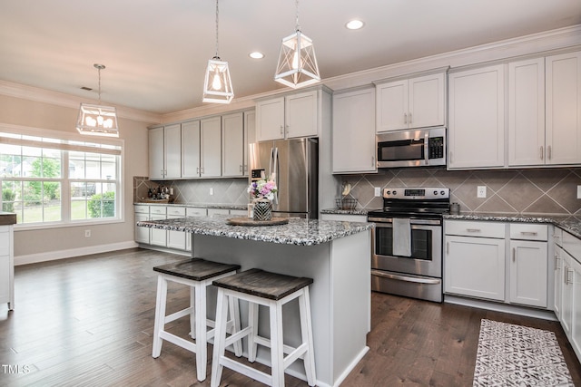 77 Redpine Ct, Clayton, NC 27520 - kitchen featuring stainless steel appliances, crown molding, stone countertops, dark wood-style flooring, and a center island