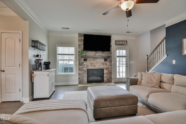 77 Redpine Ct, Clayton, NC 27520 - living area with plenty of natural light, ornamental molding, a ceiling fan, wood finished floors, and a fireplace